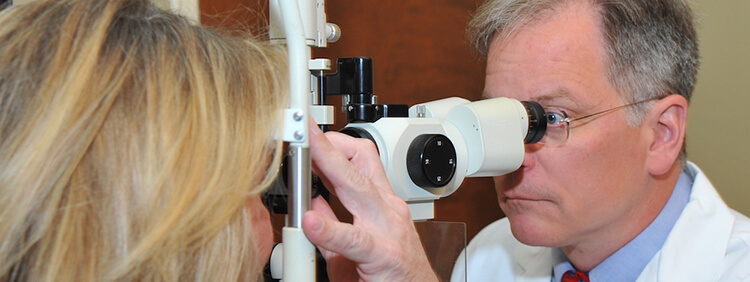 Ophthalmologist performing a glaucoma exam on patient