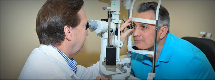 Contact Us Header: A man receives an eye examination